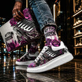 Person wearing stylish millions Pending NFEO Platform McQueen model Chunky sole sneakers with purple,  black, white, sliver, floral Skull designs with millions Pending text, holding a matching shoe box in an urban setting. Millions Pending signature sneakers for streetwear.