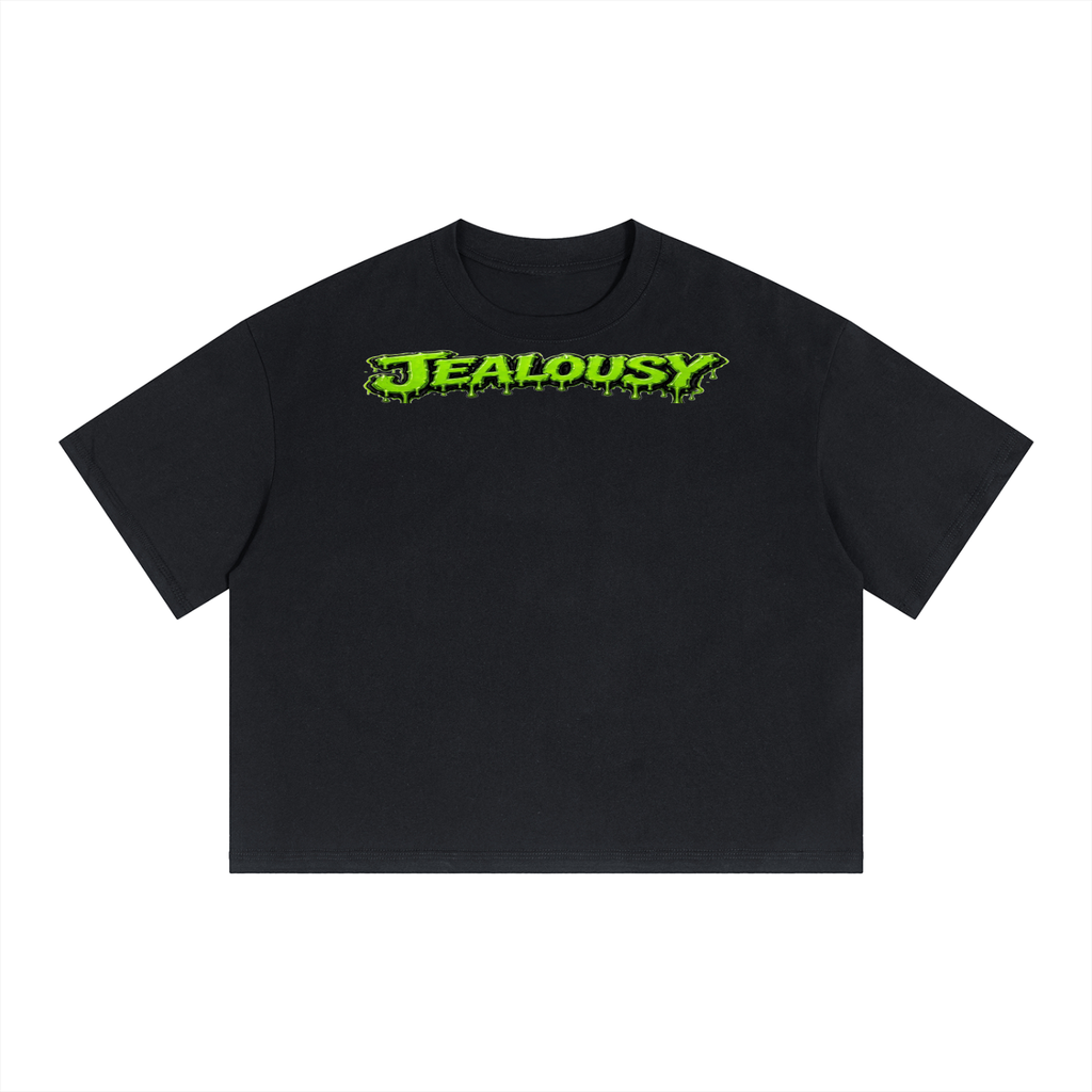 A black short-sleeve crop top t-shirt featuring a bright green 'JEALOUSY' graphic across the chest, displayed flat against a solid white background.