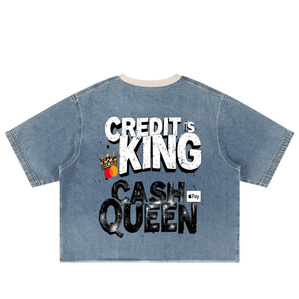 A light blue denim short-sleeve t-shirt with a graphic print on the back reading 'CREDIT'S KING CASH QUEEN' in distressed white and black lettering, featuring a small crown and '4Pay' logo, shown on a plain white background.