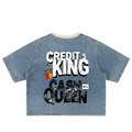 A light blue denim short-sleeve t-shirt with a graphic print on the back reading 'CREDIT'S KING CASH QUEEN' in distressed white and black lettering, featuring a small crown and '4Pay' logo, shown on a plain white background.
