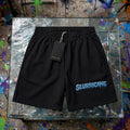 Black Slurricane boxy shorts flat lay on glass display table with hang tag - 240 GSM unisex streetwear shorts with icy blue drippy logo - ZAZA Reserve collection by Millions Pending