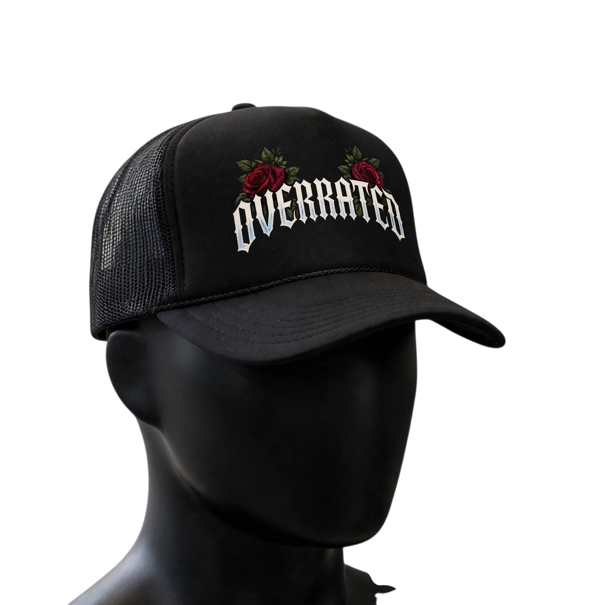 OVERRATED Premium Foam Rope Trucker Hat: Black OVERRATED premium foam rope trucker hat with breathable mesh back, curved brim, and embroidered-style OVERRATED graphic with red rose accents, displayed on a clean white background.