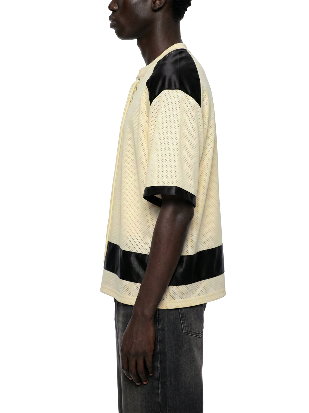Black male model wearing the NFEO Millions Pending oversized boxy mesh raglan tee in a premium luxury streetwear lifestyle setting, showcasing the SIDE/VIEW heavyweight 255 GSM breathable mesh fabric, drop shoulder fit, oversized silhouette, premium craftsmanship, and exclusive entrepreneur-inspired design. Styled with matching NFEO Millions Pending platform sneakers for a complete coordinated streetwear collection. Not For Everyone. Built For The Few.