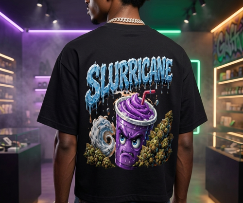 A man viewed from behind wearing a black NFEO Cannabis strain boxy drop shoulders Tee with a large graphic print on the back. The graphic features the word 'SLURRICANE' in dripping icy blue letters above a purple swirl drink with a face, surrounded by green buds and a blue wind swirls For Cannabis Streetwear Apparel