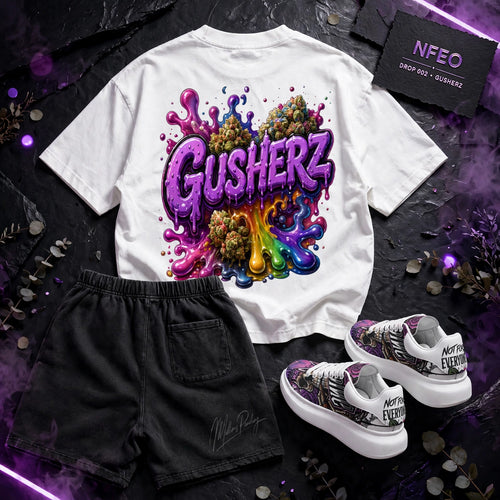 Back view Of collection set:
A white graphic T-shirt with a large colorful 'GUSHERZ' design made of cannabis leaves, styled with black shorts and white sneakers on a dark purple smoky background. Text overlays read 'NFEO ZAZA Reserve DROP 002 - GUSHERZ' and 'COMING SOON'.